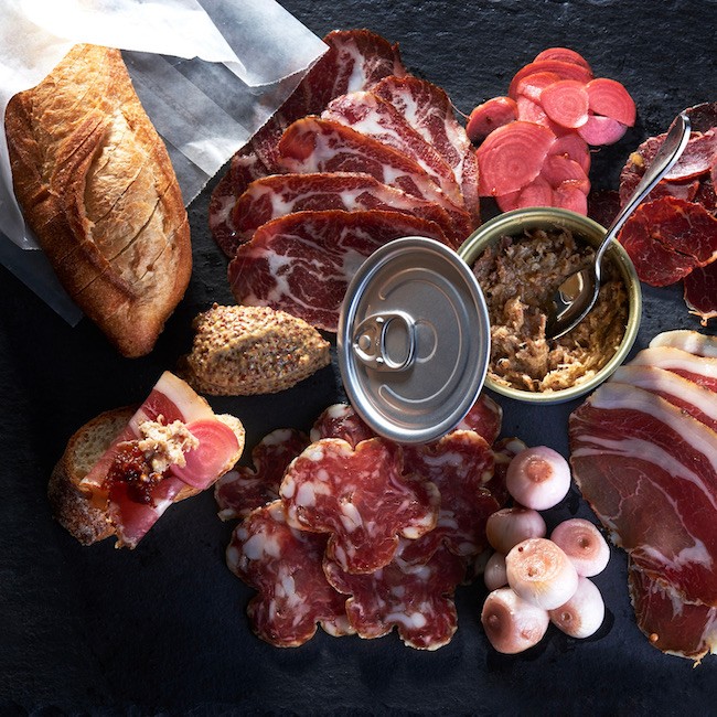 A charcuterie board full of mixed delicacies.