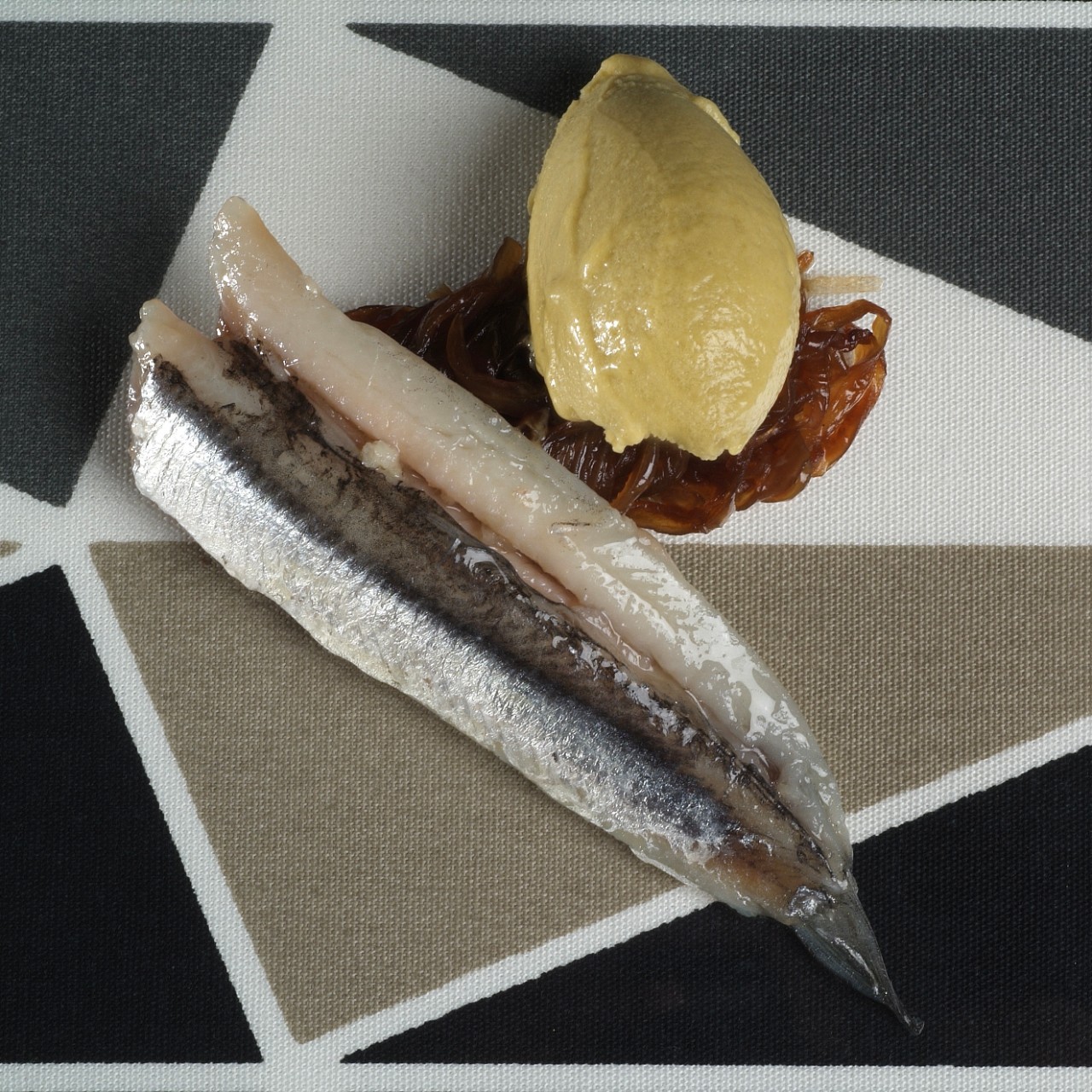 Anchovies marinated in Sherry vinegar with caramelized onion and Manzanilla olive sorbet with orange and lemon juice