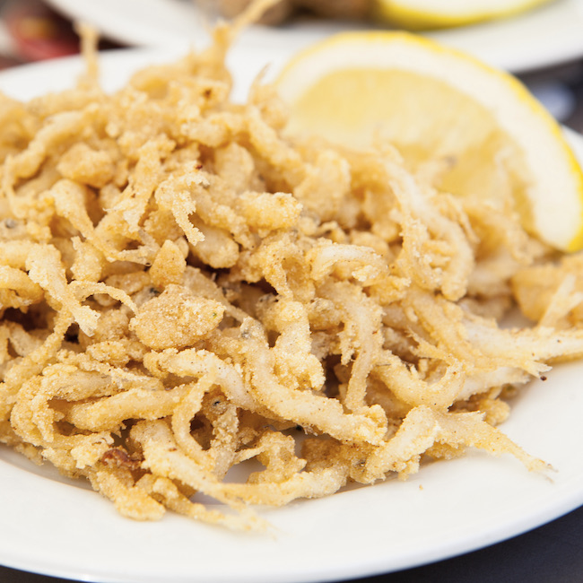 Plate of fried gobies or chanquetes with lemon, Malaga, Spain 