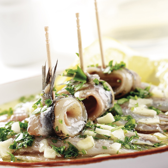 Pickled anchovies with parsley and garlic.