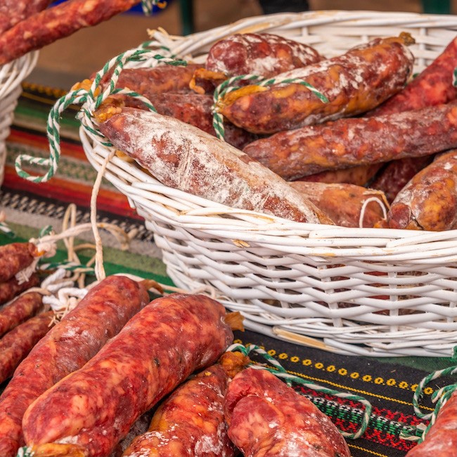 Typical Spanish sausages lying on a village stall at the food market, traditional meat products
