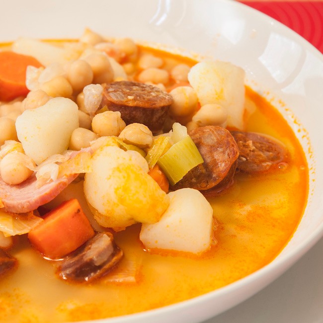 Cocido madrileño" Delicious spanish dish made with chickpeas, potatoes, carrots, sausages and beef