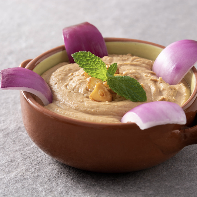 Gofio escaldado in bowl on gray stone background