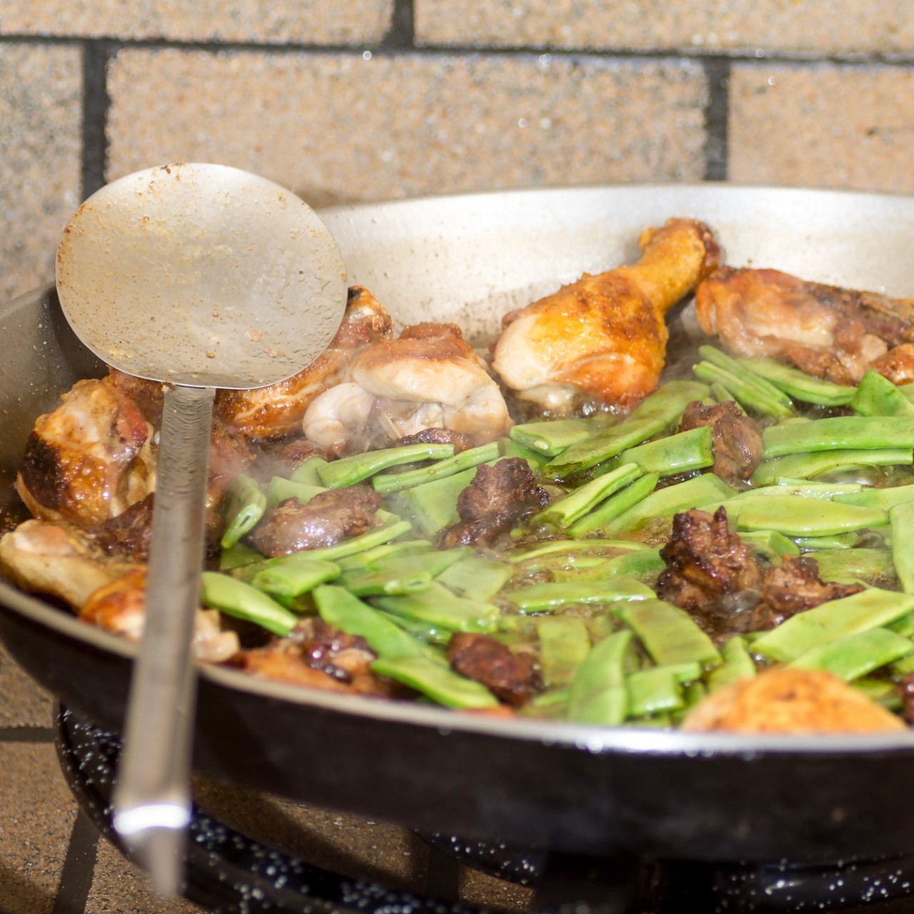 Preparation step of authentic Paella Valenciana Chicken, rabbit and vegetables