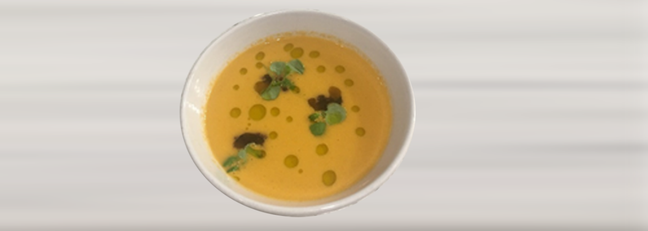Gazpacho soup with black olive tapenade and basil